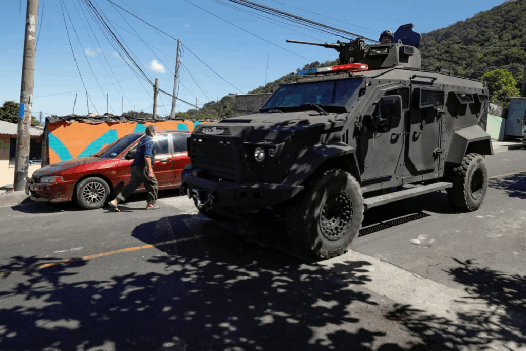 Soldiers patrol a neighborhood in San Marcos, El Salvador, in an armored vehicle on October 28, 2024, after Nayib Bukele announced the deployment of security forces to search gang remnants