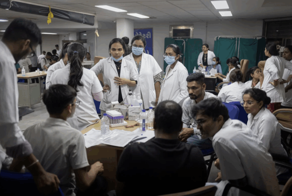 Health officials take DNA samples from family members of the victims who died when an Air India plane bound for London's Gatwick Airport crashed shortly after take-off from Ahmedabad, India on June 12.
