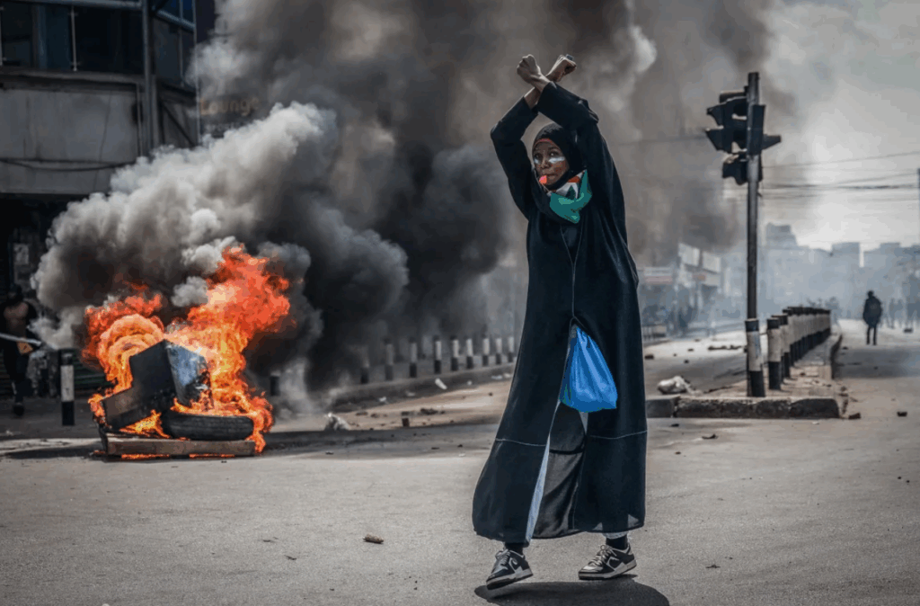A protester reacts in front of a burning barricade in downtown Nairobi on Wednesday.
