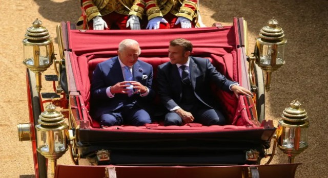 UK’s King Charles and French President Emmanuel Macron sit on a carriage as they arrive at Windsor Castle, in Windsor, Britain, July 8, 2025. Reuters
