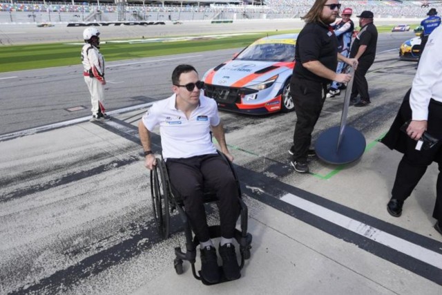 Driver Robert Wickens, who will compete in the touring car class at the Michelin Pilot Challenge auto race, wheels along pit road during a practice session for the Rolex 24 hour auto race at Daytona International Speedway, Thursday, Jan. 25, 2024, in Daytona Beach, Fla. (AP Photo)


