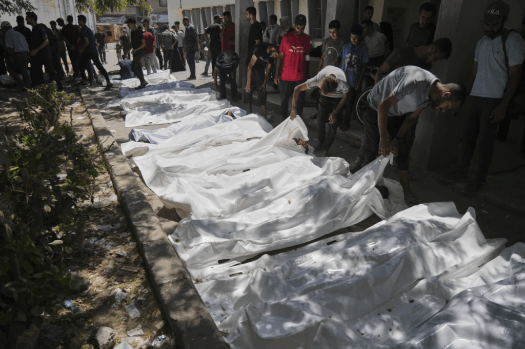 The bodies of Palestinians who were killed while attempting to access aid trucks entering northern Gaza through the Zikim crossing with Israel are brought to a clinic in Gaza City, Sunday, July 20, 2025.
