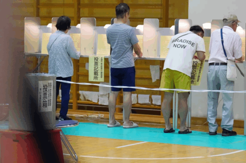 Voters fill in their ballots in the upper house election at a polling station Sunday, July 20, 2025, in Tokyo.
